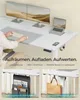 A person using a standing desk with dual monitors, a laptop, and accessories. Produktbild-Vorschau