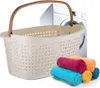 A laundry basket with a washing machine in the background and rolled towels in the foreground. Produktbild-Vorschau