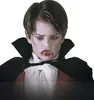 A child dressed as a vampire, wearing a cape and fake fangs. Produktbild-Vorschau