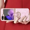 A person is holding a pink glittery phone case with a gold ring holder. Produktbild-Vorschau