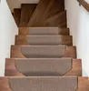 A set of brown stair treads on wooden stairs. Voir les images du produit
