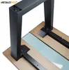 Close-up view of a black metal table leg assembly attached to a wooden tabletop with a light blue insert. Produktbild-Vorschau