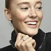 A woman is smiling and showing off a ring on her finger. Náhľad obrázku produktu