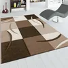 A modern living room with a geometric rug, a chaise lounge, and a bookshelf. Anteprima dell’immagine prodotto