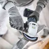 A person wearing gloves is using an angle grinder to cut a metal pipe, with sparks flying. Produktbild-Vorschau
