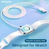 A white magnetic charging cable for an Apple Watch is shown connected to the watch, with the cable coiled in the background. Produktbild-Vorschau
