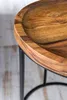 A close-up view of the edge of a wooden table with a black metal frame. Náhled obrázku produktu