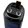 A close-up view of the top panel of a black portable speaker with a smartphone inserted into a holder. Produktbild-Vorschau