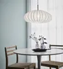 A pendant light hangs over a round dining table with two chairs. Podgląd zdjęcia produktu