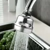 A close-up shot of a faucet sprayer head with water spraying into a sink with broccoli in it. Produktbild-Vorschau