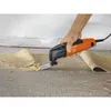 A person is using an oscillating multi-tool to remove old flooring material. Produktbild-Vorschau