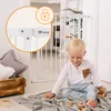 A young child is playing on the floor in front of a white baby gate. Náhľad obrázku produktu