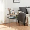 A small side table with decorative items and books next to a sofa. Náhľad obrázku produktu