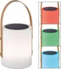 A collage of solar-powered lanterns, with one main lantern shown in white and three smaller examples in red, green, and blue. Produktbild-Vorschau