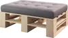 A close-up shot of a wooden pallet ottoman with a gray tufted cushion. Produktbild-Vorschau