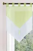A close-up view of a green and white valance curtain hanging on a window rod.