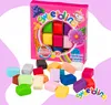 A box of colorful edible sugar dough and scattered pieces of the dough on a pink and white background. Produktbild-Vorschau