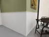 A corner of a room with wainscoting and a painting on the wall, and a table with chairs. Produktbild-Vorschau