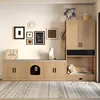A pet furniture unit with a dog bed and a cat enclosure, decorated with wall art and plants. Produktbild-Vorschau