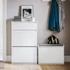 A modern hallway storage setup with a tall white cabinet, a white storage bench with a gray cushion, and clothes hanging on a rack above. Anteprima dell’immagine prodotto