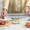 A person is using a vacuum sealer to package food, with raw meat and vegetables visible. Produktbild-Vorschau
