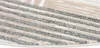 A close-up view of a round rug with a striped pattern. Produktbild-Vorschau