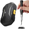 A hand holds a precision screwdriver set next to its case, with a pile of screws in the foreground. Voir les images du produit