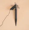 A close-up of a solar-powered garden light stake with a wire. Produktbild-Vorschau