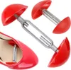 A product shot of red shoe trees, with one shoe tree partially inserted into a red shoe. Produktbild-Vorschau