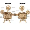 A diagram showing the left and right views of a wooden 3D puzzle film projector model, with labels pointing out various parts and functions. Produktbild-Vorschau