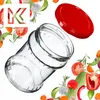 A glass jar and its red lid are shown surrounded by various fresh vegetables and herbs, with a stylized 'K' logo in the upper left corner. Produktbild-Vorschau