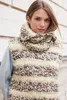 A woman wearing a knitted vest and cowl. Produktbild-Vorschau