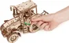 A hand is shown opening the door of a wooden tractor model. Náhľad obrázku produktu