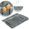 Collage showing a folded gray fabric organizer with multiple compartments, and close-up views of the compartments holding hairbrushes and a hook for hanging. Produktbild-Vorschau