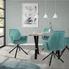 A dining room scene with teal velvet chairs around a wooden table. Náhled obrázku produktu