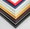 A close-up, angled view of stacked picture frame samples in various colors. Produktbild-Vorschau
