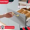 A hand is shown opening a kitchen drawer with a gold handle. Produktbild-Vorschau
