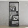 A black metal bookshelf with various decorative items on its shelves, set against a textured gray wall. Produktbild-Vorschau