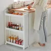 A person is preparing food in a kitchen next to a white rolling storage cart filled with food items. Produktbild-Vorschau