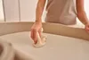 A person is cleaning a baby changing table with a cloth. Náhľad obrázku produktu