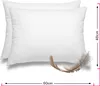 Two white pillows are shown side-by-side, with a feather in the foreground. Náhľad obrázku produktu
