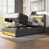 A modern bedroom with a grey upholstered bed frame, featuring a lift-up mattress for storage and integrated LED lighting. Náhľad obrázku produktu