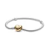A silver Pandora bracelet with a gold heart-shaped clasp. Produktbild-Vorschau