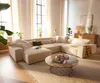 A spacious living room with a large sectional sofa, coffee table, and curtains.