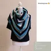 A knitted shawl displayed on a mannequin. Produktbild-Vorschau