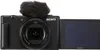 A black Sony ZV-1 II digital camera with a furry microphone attachment and its screen flipped out. Produktbild-Vorschau