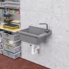A utility sink mounted on a concrete wall in a workshop or garage setting, with storage bins and tools nearby. Podgląd zdjęcia produktu