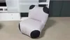 A single, light gray armchair with black accents is placed on a light gray carpet in front of a white shelving unit. Produktbild-Vorschau