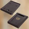 Two views of a brown plastic mailbox, one showing the underside and the other showing the top with a postal logo. Náhled obrázku produktu