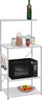 A white microwave shelf unit with various items on its shelves. Náhled obrázku produktu
